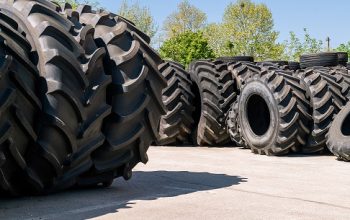 Big,Machines,Tires,Stack,Background.,Industrial,Tires,Outside,For,Sale